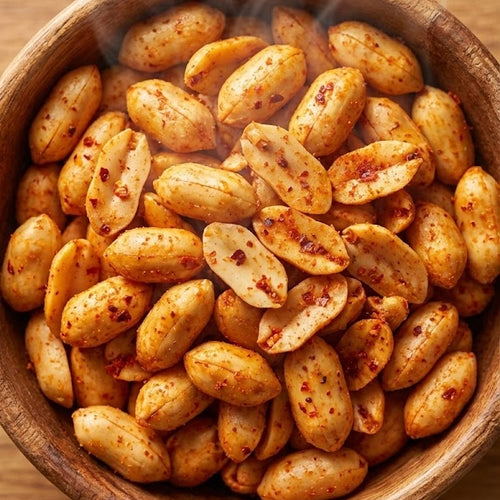 Wooden bowl filled with roasted peanuts on a wooden surface